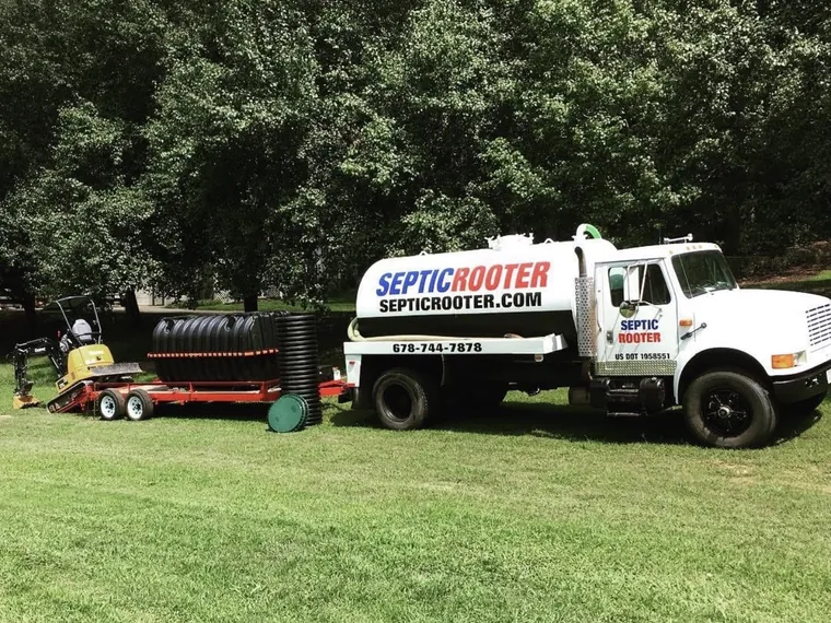 SepticRooter pump truck with leach-field chambers and a mini-excavator