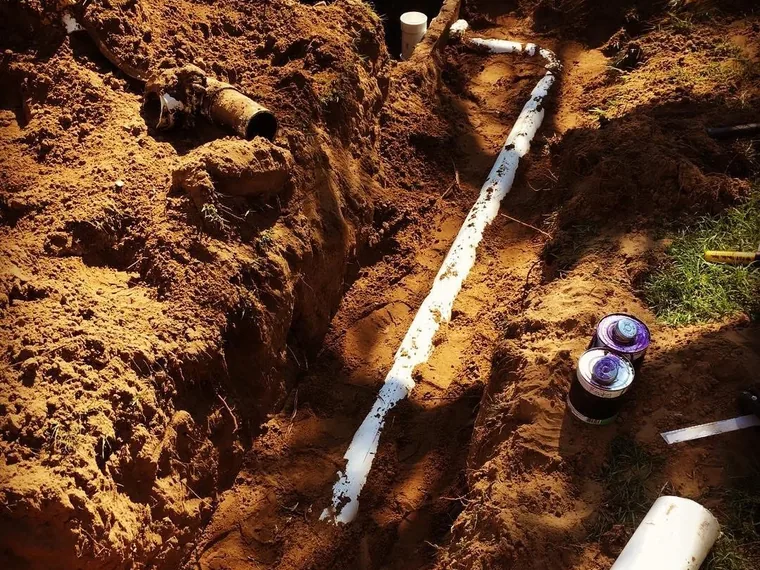 New sewer line set in an open trench during a septic repair